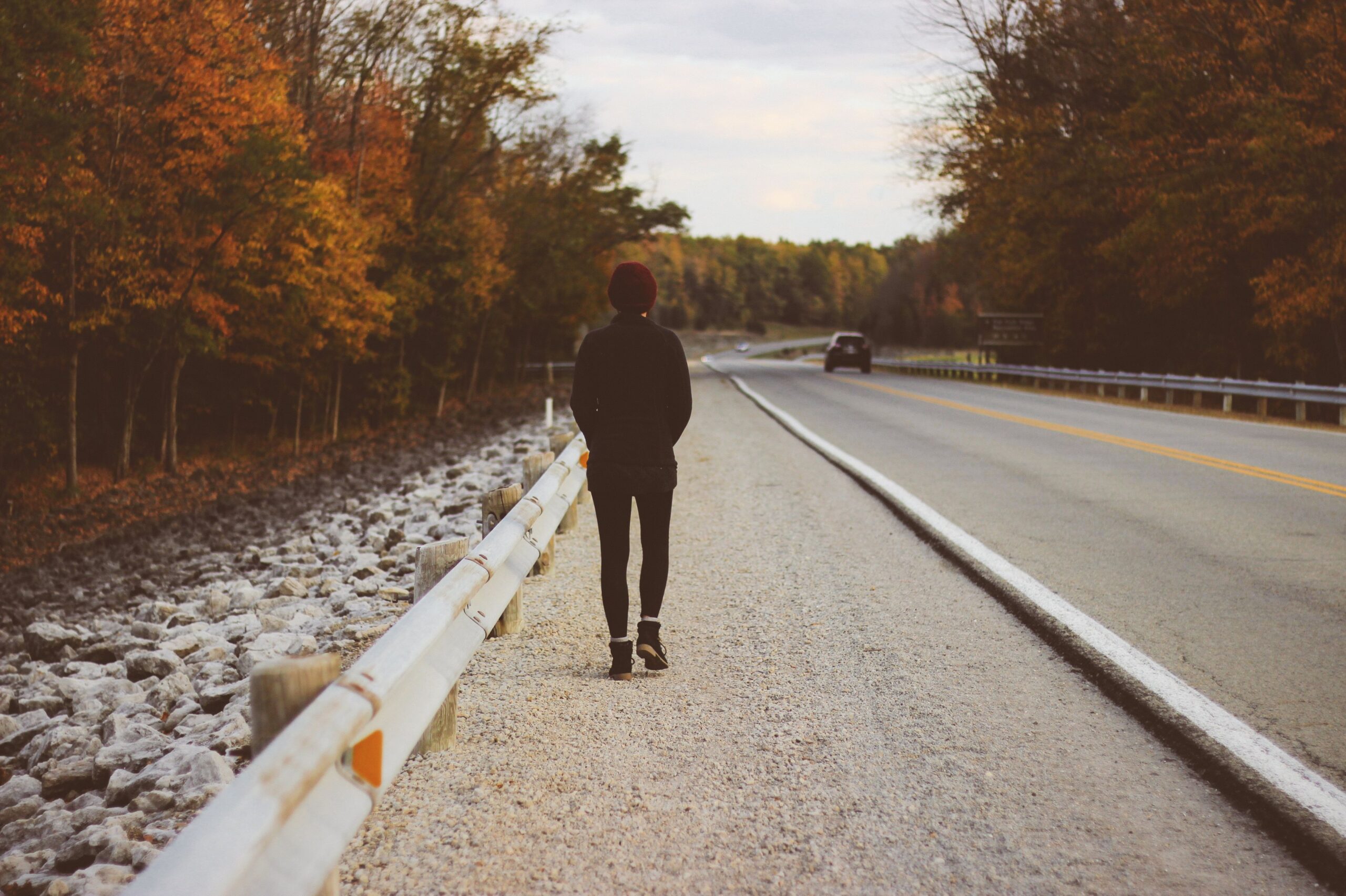 man walking on road